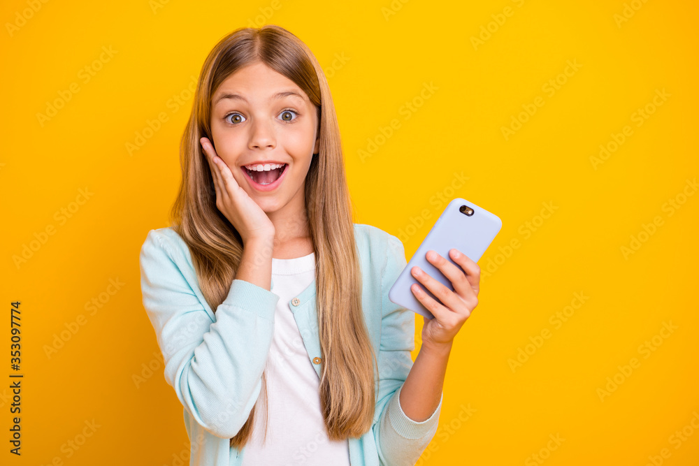 Photo of beautiful pretty little blond lady good mood hold telephone hands read post comments see reposts followers arm on cheek wear casual blue shirt isolated yellow color background Photo of beautiful pretty little blond lady good mood hold telephone hands read post comments see reposts followers arm on cheek wear casual blue shirt isolated yellow color background