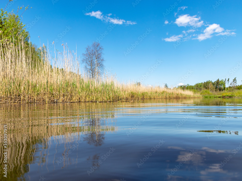 landscape with a beautiful river in spring, cloud reflections in the water