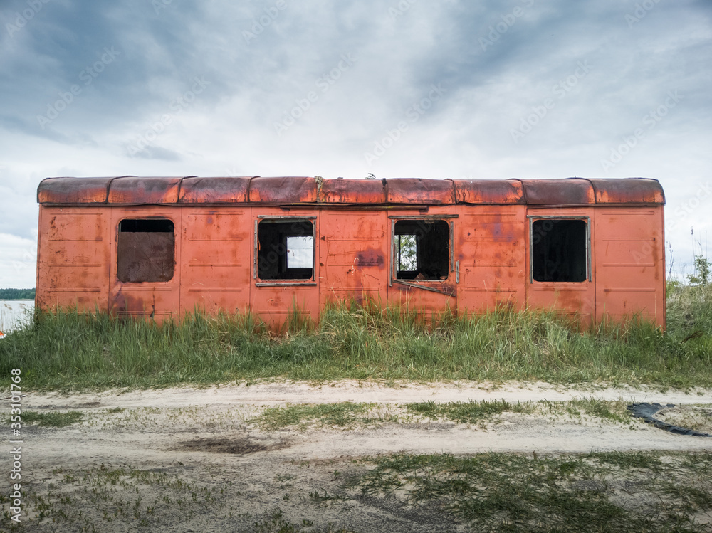 Old rusty abandoned wagon on a cloudy day. Old rusty abandoned wagon on a cloudy day.