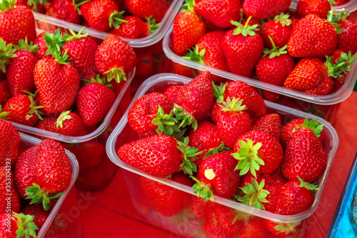 Tasty juicy strawberry berries in boxes  on the market