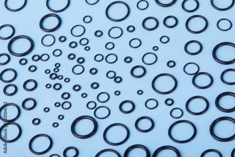 Black hydraulic and pneumatic oring seals of different sizes a blue