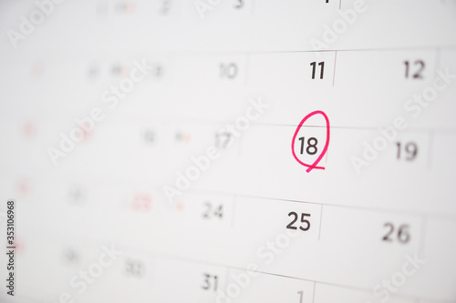 Red circle mark at 18th on calendar date business planning appointment meeting concept