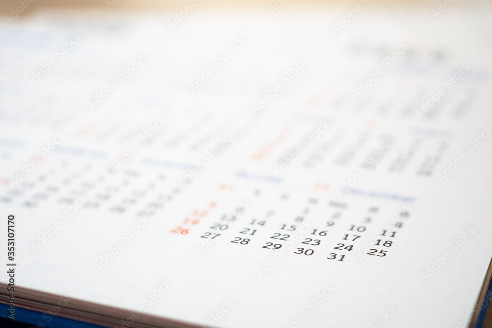 Close up calendar page dates abstract blurred background business planning appointment meeting concept