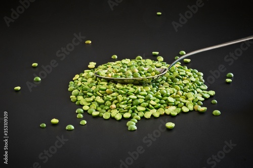 Green lentils isolated as a simple ingredient on black background