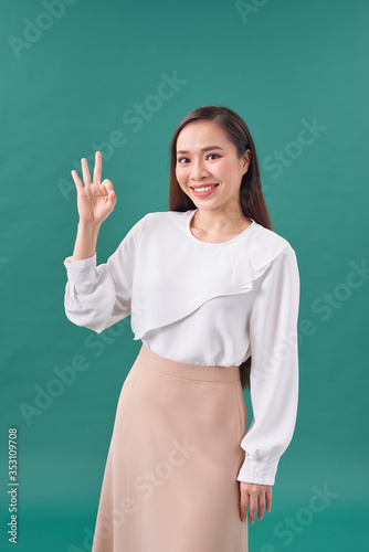 Business woman show ok symbol. Toothy smiling business woman portrait.