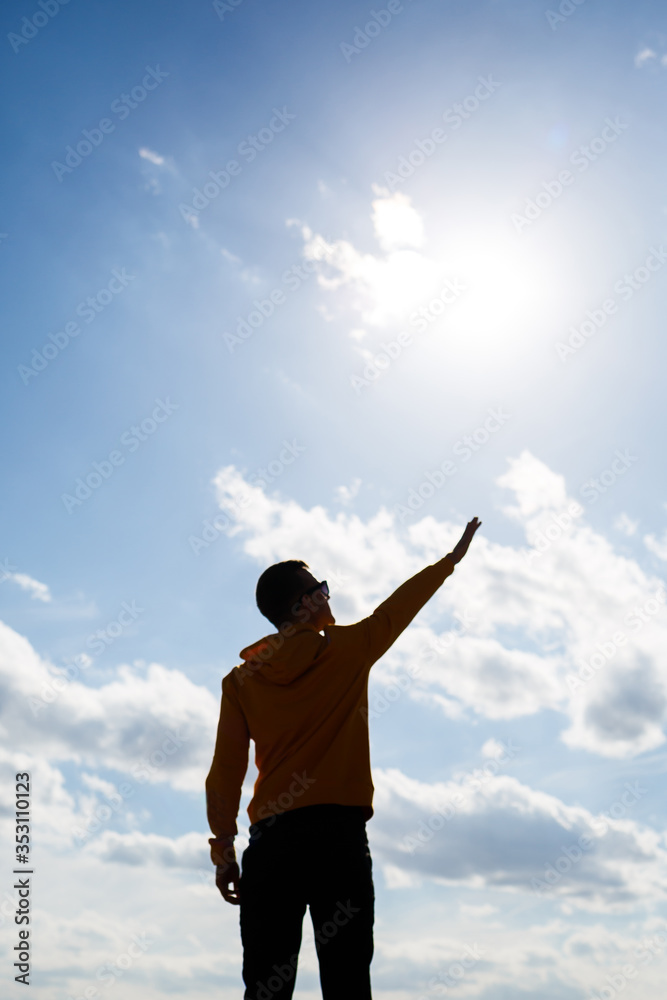 guy tourist freelancer on a background of blue sky with white clouds, bright sunny day, nature and human freedom guy tourist freelancer on a background of blue sky with white clouds, bright sunny day, nature and human freedom
