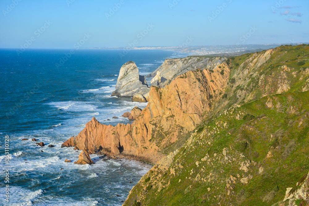 View of the Atlantic ocean and cliffs at Cabo da Roca, Portugal, in the early evening light. Cabo da Roca, near Cascais, is the westernmost point of Europe