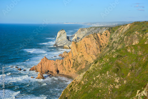 View of the Atlantic ocean and cliffs at Cabo da Roca, Portugal, in the early evening light. Cabo da Roca, near Cascais, is the westernmost point of Europe