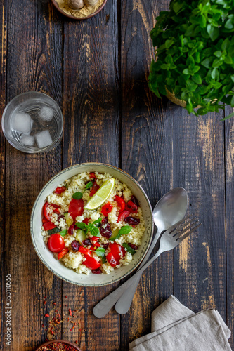 Couscous salad with tomatoes, peppers, courgettes and cranberries. Vegetarian food. Diet. Healthy eating. photo