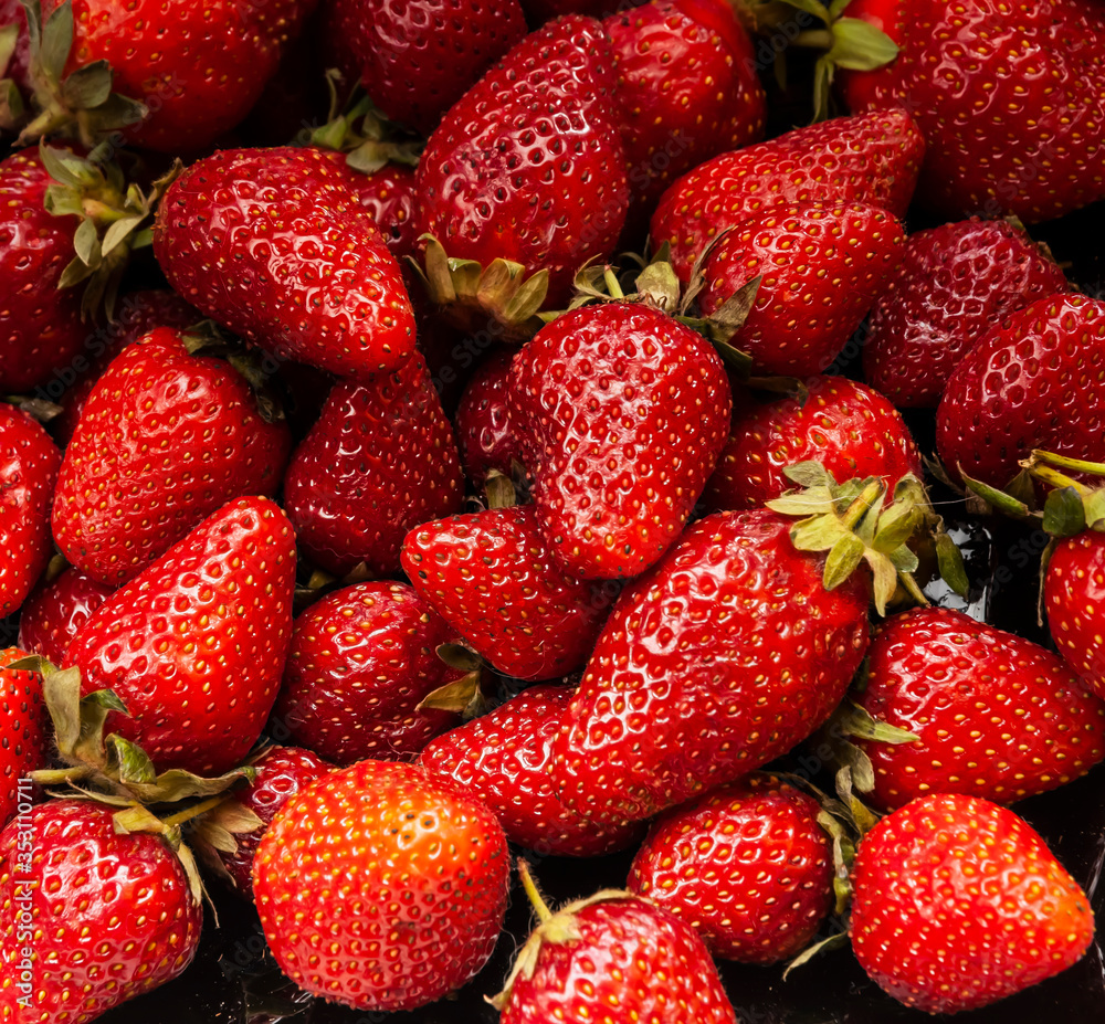 Close-up of fresh tasty strawberries. Ripe strawberry background Close-up of fresh tasty strawberries. Ripe strawberry background