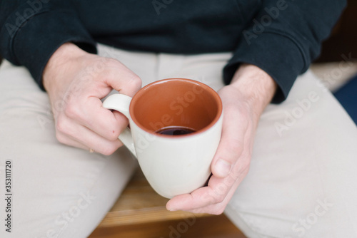 Man s hands with a cup of coffee