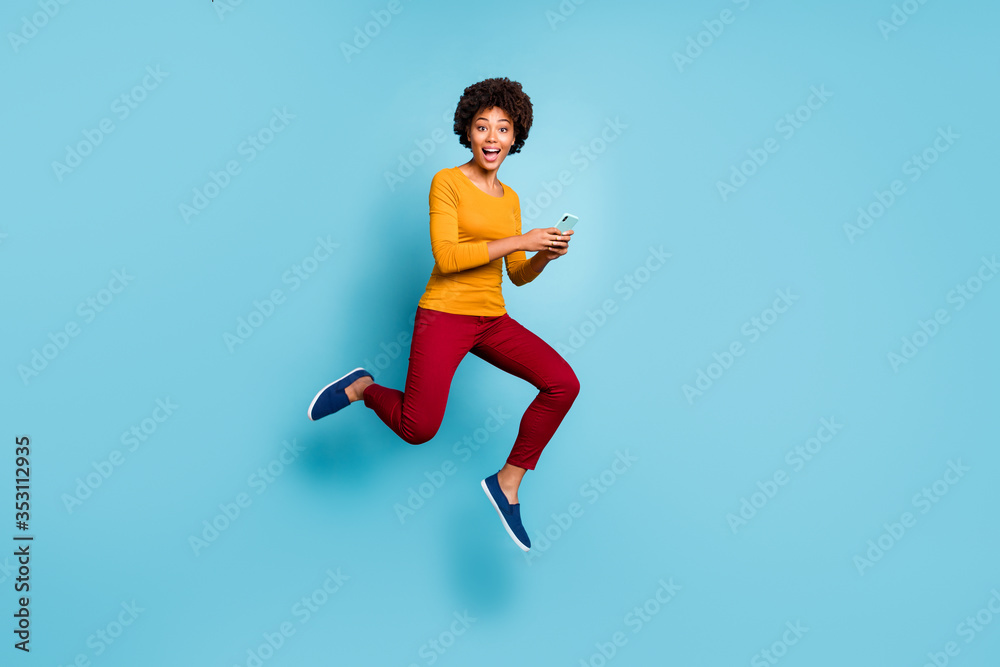 Full length body size view of her she nice attractive lovely glad cheerful cheery wavy-haired girl jumping running fast using cell smm isolated on bright vivid shine vibrant blue color background Full length body size view of her she nice attractive lovely glad cheerful cheery wavy-haired girl jumping running fast using cell smm isolated on bright vivid shine vibrant blue color background