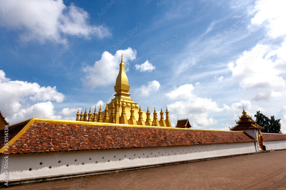 Naklejka premium Phra That Luang .The Golden Pagoda place of travel landmark and Famous in vien tien Laos on a clear day