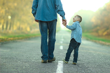 father and son walk in nature