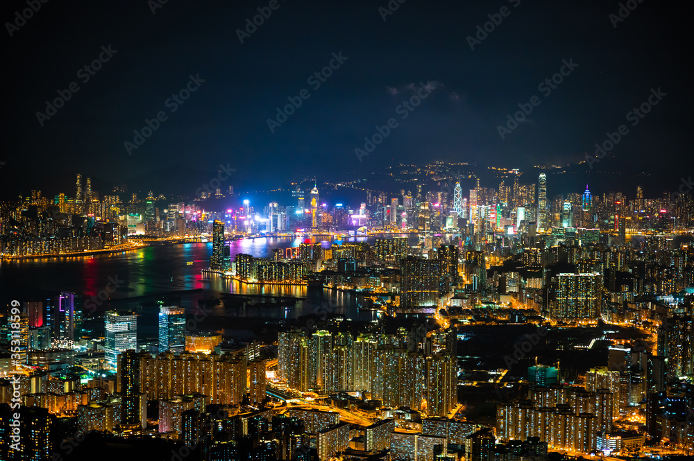 panorama cityscape view of Hong Kong at night, the atmosphere of night lights in the city of the harbor, trade, transportation and international export of China