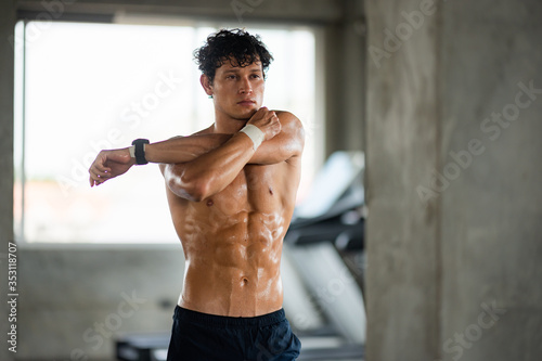 handsome man exercising workout in the sport gym, Health concepts, exercise ,and muscle care are the new normal of life that requires health care photo