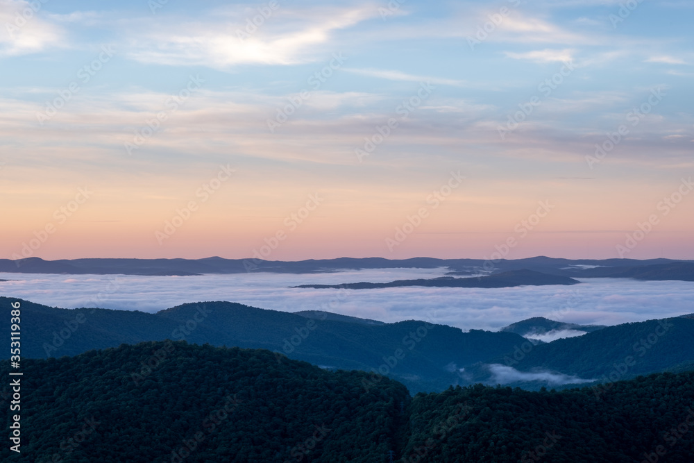 Scenic sunrise view from the Blue Ridge Parkway of Looking Glass Rock, a popular climbing and hiking destination attraction in Pisgah Forest of Brevard, near Asheville, North Carolina Scenic sunrise view from the Blue Ridge Parkway of Looking Glass Rock, a popular climbing and hiking destination attraction in Pisgah Forest of Brevard, near Asheville, North Carolina