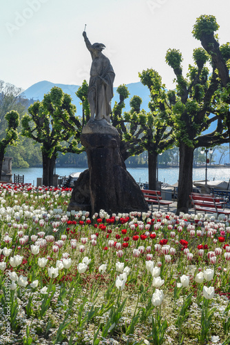 Public garden with a statue of Willhelm Tell on the lakefront at Lugano on Switzerland photo