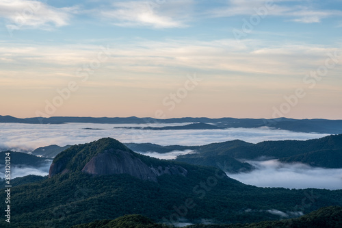 Scenic sunrise view from the Blue Ridge Parkway of Looking Glass Rock  a popular climbing and hiking destination attraction in Pisgah Forest of Brevard  near Asheville  North Carolina