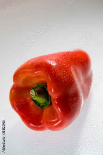 Fresh red whole pepper on the white background