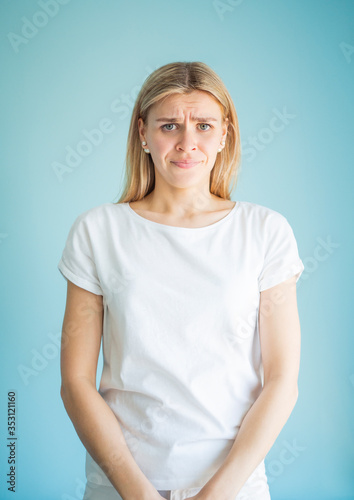 Guilty feminine facial expression. Portrait of woman frowns her eyebrows