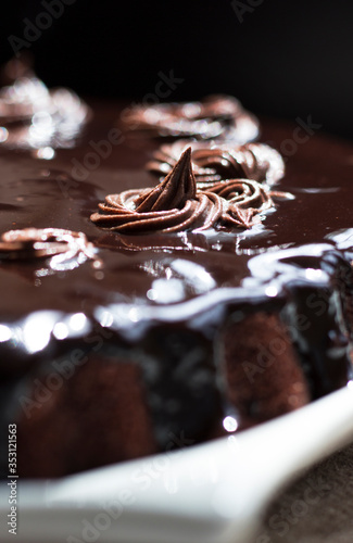 chocolate cake with chocolate syrup on white ceramic plate