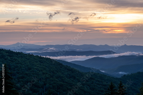 Fototapeta Naklejka Na Ścianę i Meble -  Scenic sunrise view of the Blue Ridge Mountains near Asheville, North Carolina from the Blue Ridge Parkway, a scenic byway stretching across the mountains of western NC.