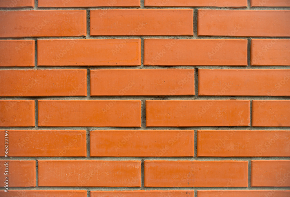 Orange bricks wall close up background. New built brick wall texture. Orange bricks wall close up background. New built brick wall texture.
