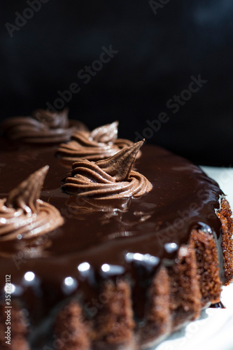 chocolate cake with chocolate syrup on white ceramic plate