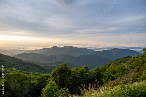 Scenic sunrise view of the Blue Ridge Mountains near Asheville, North Carolina from the Blue Ridge Parkway, a scenic byway stretching across the mountains of western NC.