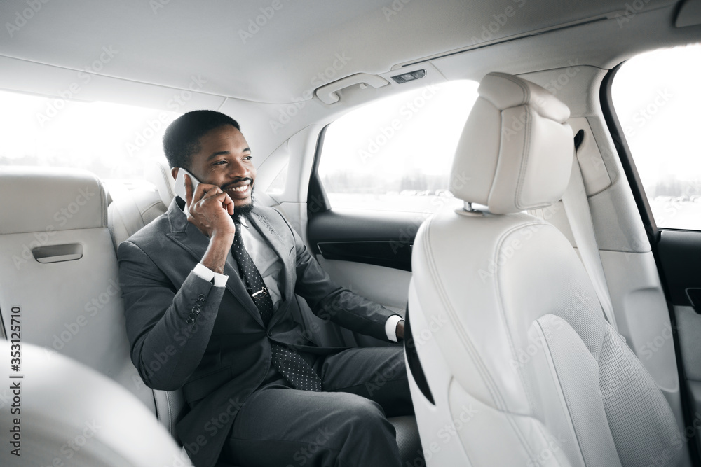 Successful Businessman Talking On Phone Sitting In Luxury Car
