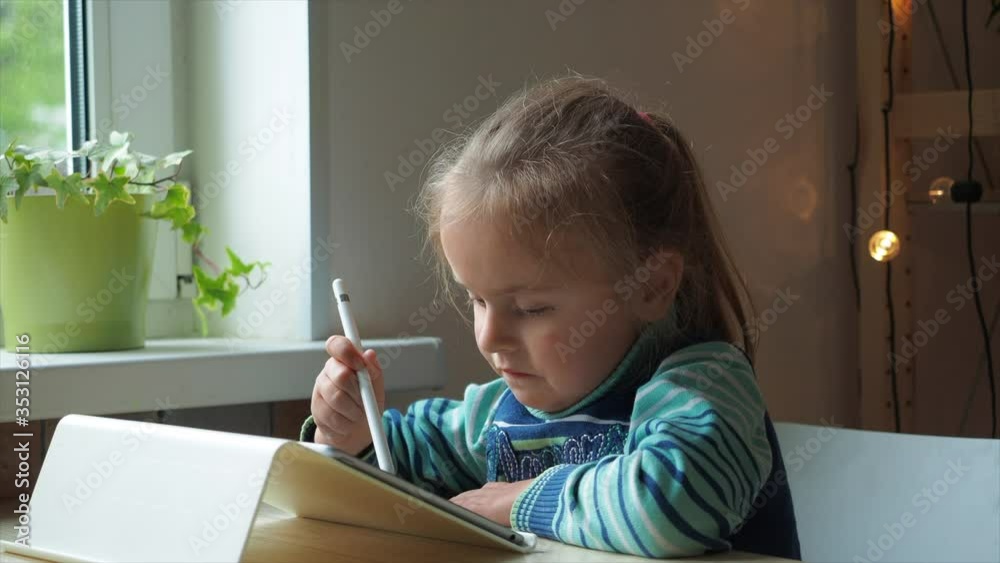 Little girl with tablet and stylus learning drawing online Little girl with tablet and stylus learning drawing online
