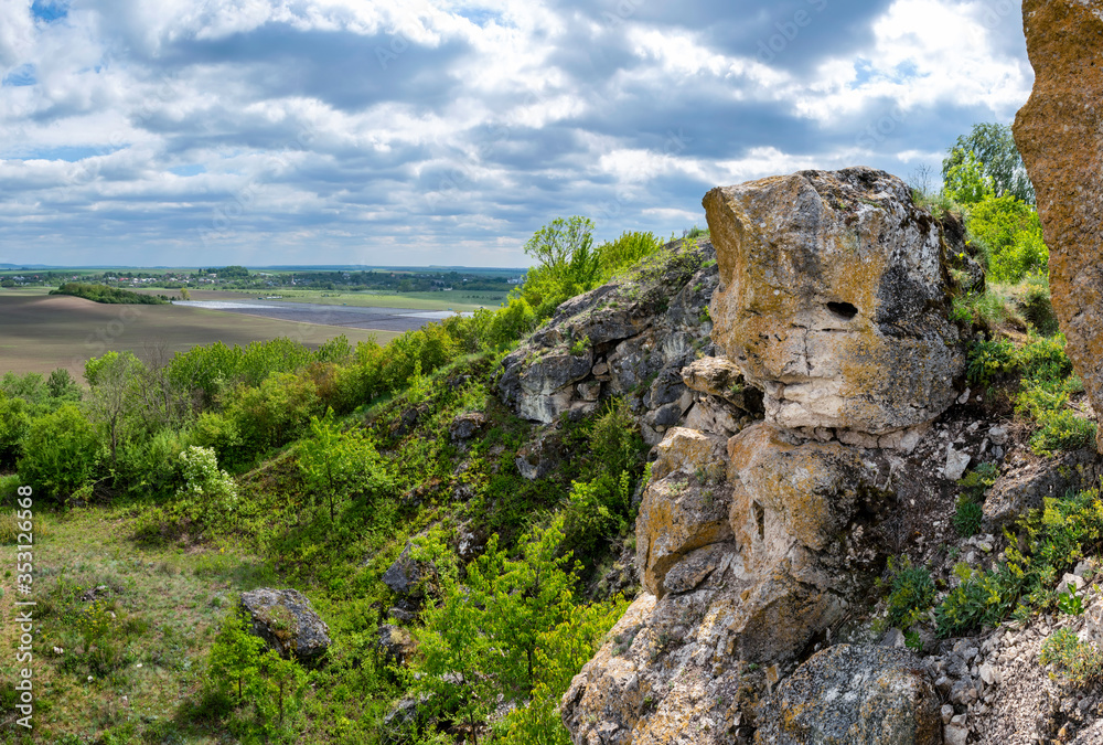 Landscape with stony hills and blue sky with beautiful clouds. Ukraine, Medobory Nature Reserve