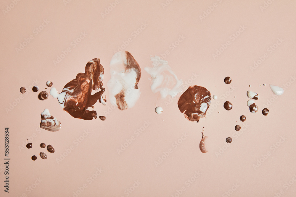 top view of melted brown and white ice cream on pink background - obrazy, fototapety, plakaty 