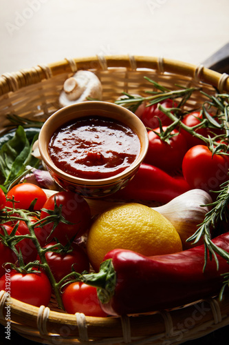 delicious tomato sauce with fresh ripe vegetables in basket © LIGHTFIELD STUDIOS