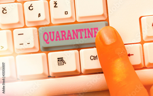 Writing note showing Quarantine. Business concept for restraint upon the activities of an individual or the transport of goods photo
