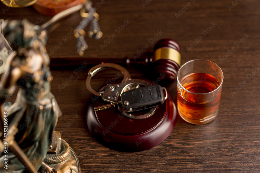 Whiskey with car keys and handcuffs. Concept for drinking and driving Whiskey with car keys and handcuffs. Concept for drinking and driving