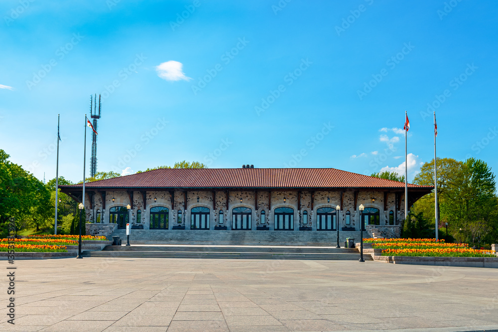 Mount Royal Chalet at the top of Mount Royal in Montreal Quebec, tulip gardens on the patio on a beautiful spring day with blue sky's and clouds