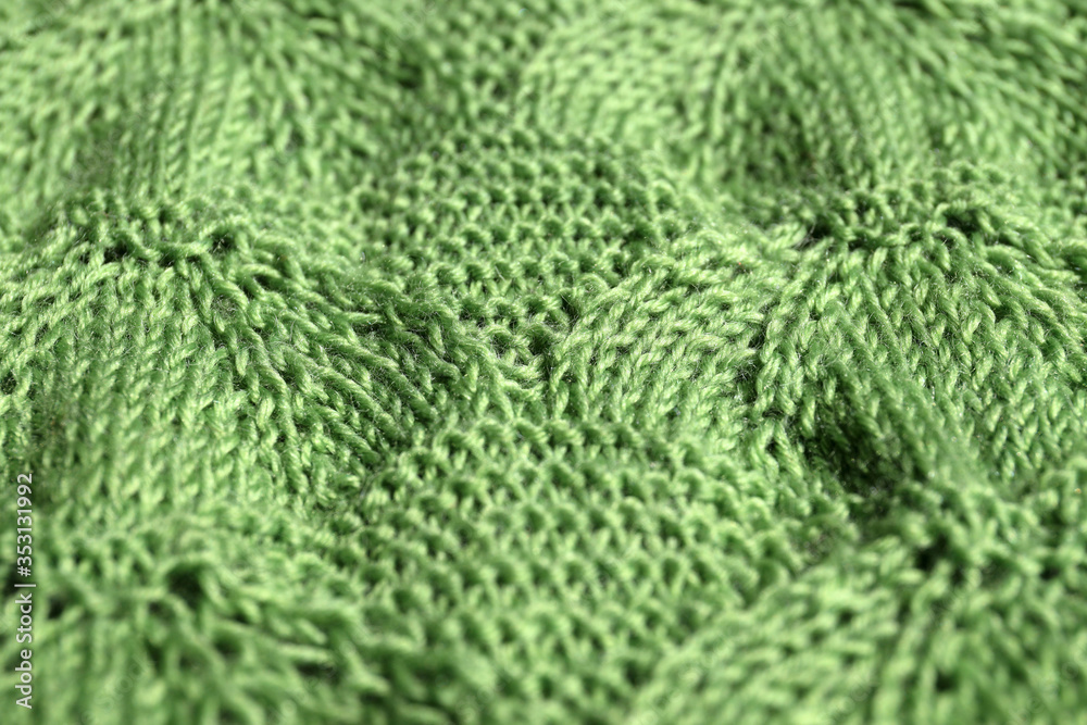 Texture of green knitting from wool. A shallow depth of field closeup. Texture of green knitting from wool. A shallow depth of field closeup.
