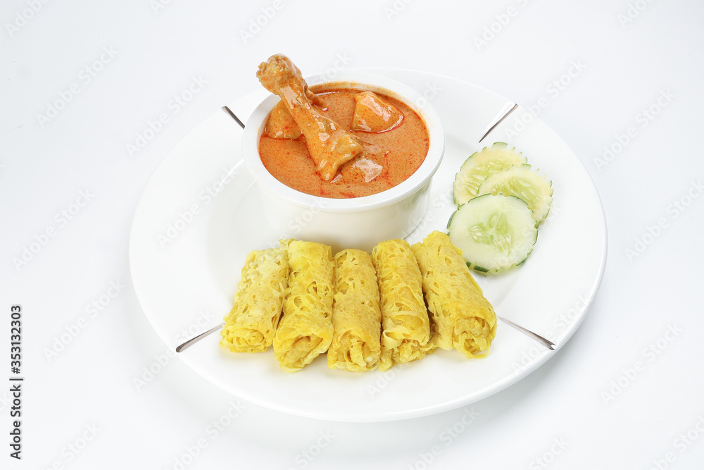 Traditional Malay snack food Roti Jala served with curry chicken with potato on white ceramic plate and bowl Traditional Malay snack food Roti Jala served with curry chicken with potato on white ceramic plate and bowl