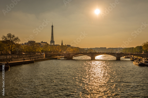 sunset over Seine River in Paris with Eiffel tower and Pont des Invalides bridge