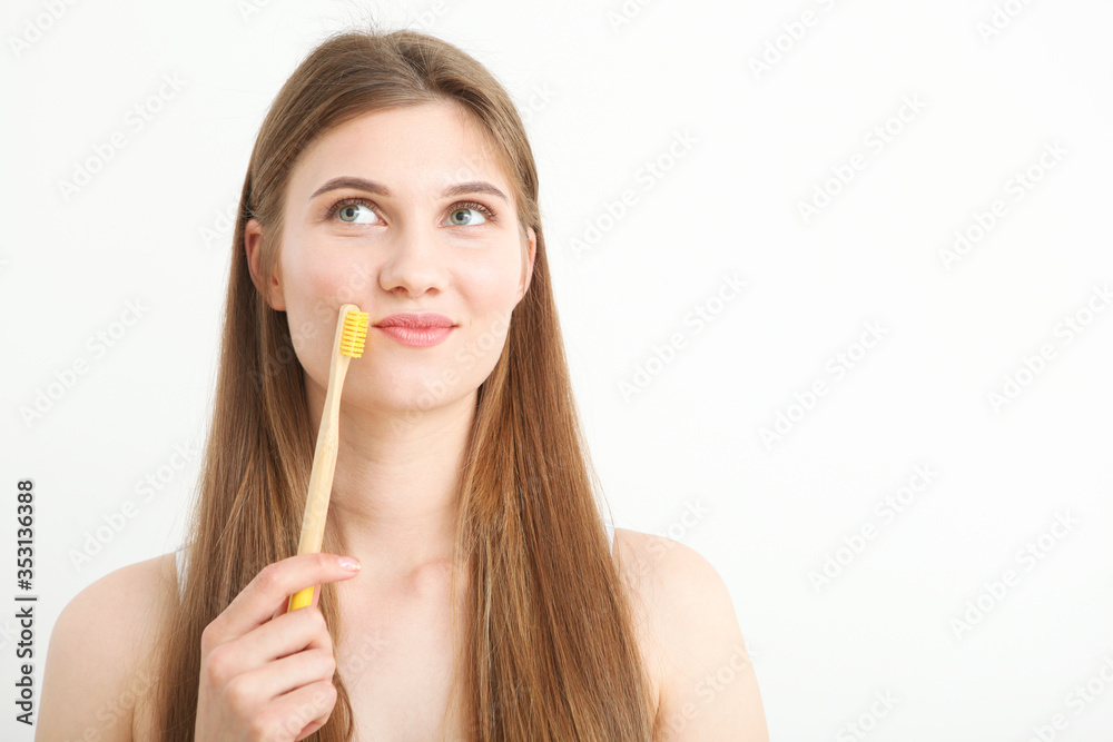 girl with a toothbrush on a light background. dental care
girl with a toothbrush on a light background. dental care