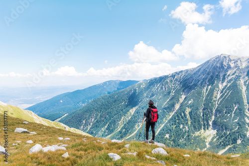 Hiker Woman with Backpack on the Top of a Mountain with Stunning View.Pirin Mountain ,Bulgaria 