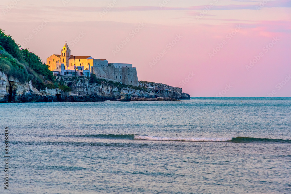 south italy background of Vieste church village at sunset by the sea with purple sky