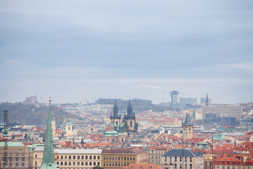 Panorama of Prague, Czech Republic, seen from the top of the castle, during an autumn cloudy afternoon. Major tourist landmarks such as medieval towers, cathedrals and churches, are visible