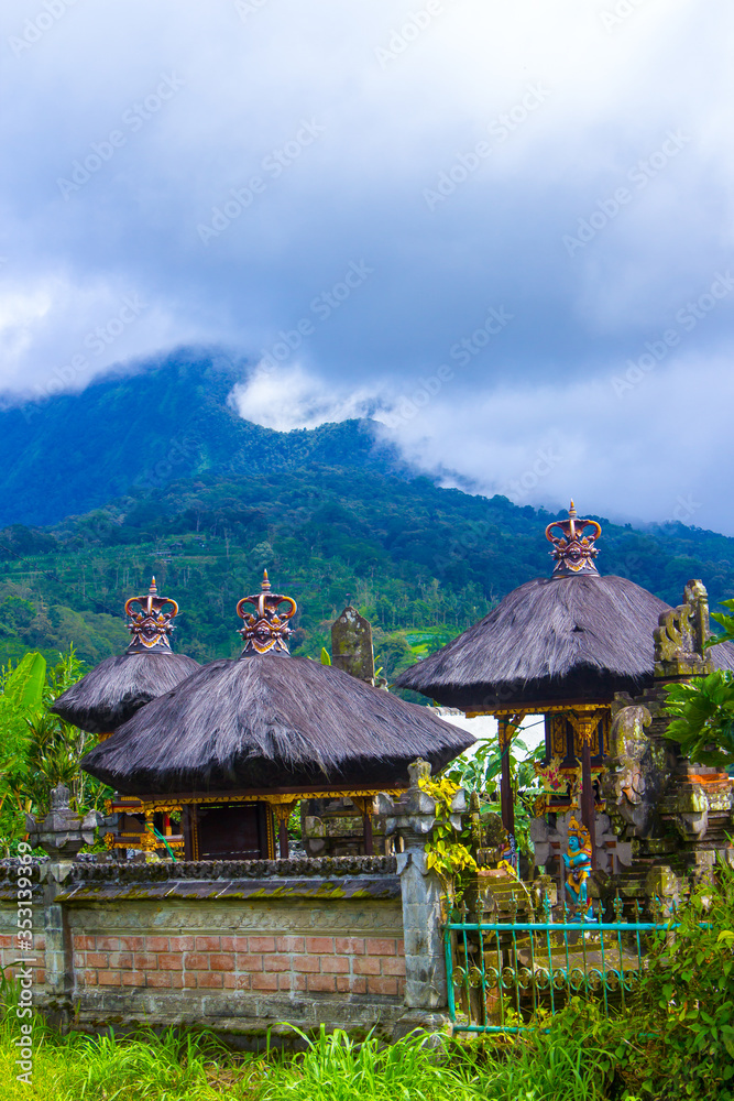 view of the village house in Bali with clouds and mountains in the background view of the village house in Bali with clouds and mountains in the background