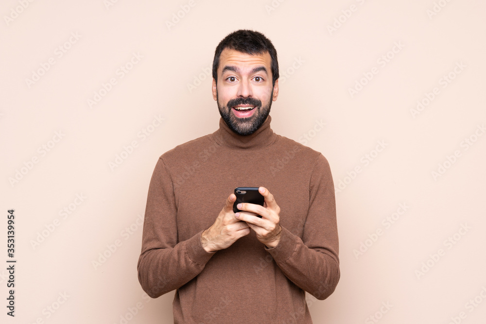 Man over isolated background surprised and sending a message Man over isolated background surprised and sending a message