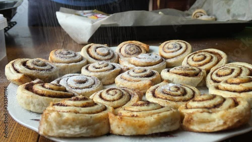 Baked cinnabons sprinkled with powdered sugar