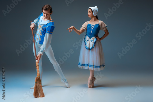 Young and graceful ballet dancers as Cindrella fairytail characters on studio background. Art, motion, action, flexibility, inspiration concept. Flexible caucasian ballet dancers posing, dancing. photo