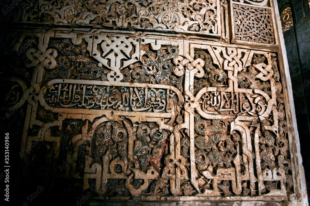 Islamic calligraphy and example of medieval architecture in Andalusia, patterned walls the 4th century palace Alhambra